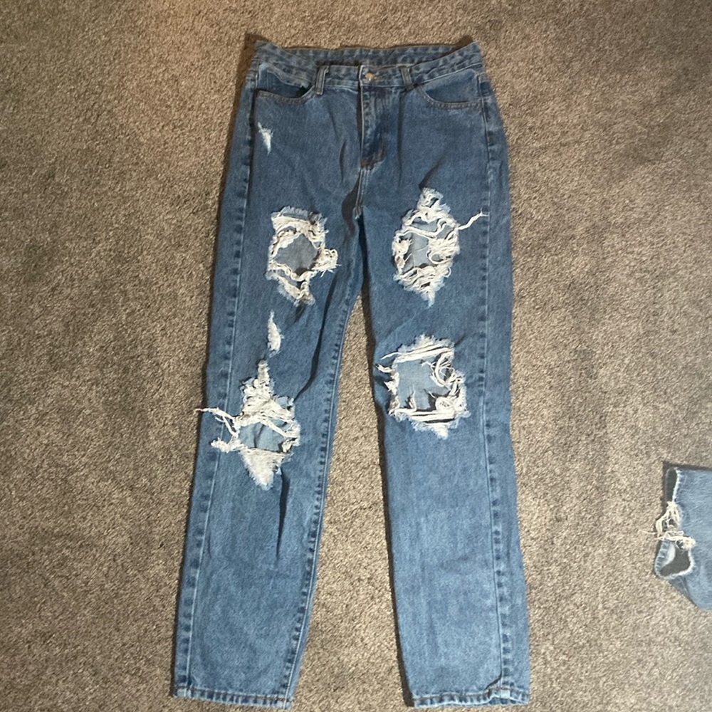 size large holed jeans. baggie fit.